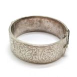 Silver hallmarked bangle with engraved detail to front - 5.5cm internal diameter & 34g