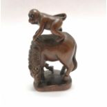 Carved wooden figure of a monkey on a horse as an oriental toggle with bead eyes 5cm high