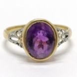 Unmarked (touch tests as 18ct) white & yellow gold amethyst ring with diamond set shoulders - size P