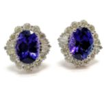 Unmarked (touch tests as 18ct white gold) tanzanite & diamond cluster pair of earrings - total