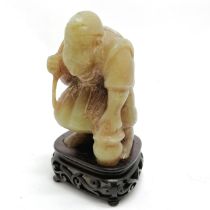 Oriental Chinese antique hand carved jade figure of a fisherman on a carved wooden stand with an old