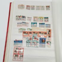 Red stockbook with qty of mostly mint USA t/w Christmas stamps, Hawaii, booklets (some evidence of