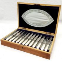 Cased set of 12 mother of pearl handles fruit knives and forks, with silver band for Sheffield 1912,