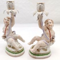 Pair of Continental Putti candlesticks, 31 cm high, 18 cm wide. in good used condition.