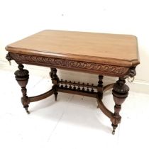 Antique French oak centre table with carved lion mask handles to the corners, with shaped and turned