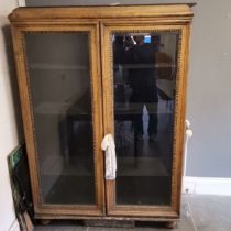 Large oak bevelled glazed 2 door cabinet, on bun feet with original key - base and feet need