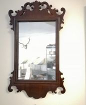 Antique mahogany fret carved wall mirror - 68cm x 40cm - in good used condition