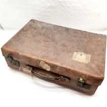 Vintage leather suitcase, with red tooled leather interior, bearing some interesting labels to