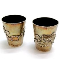 Pair of Oriental Chinese 900 silver beakers with floral detail by WK - 5.5cm high & 101g total