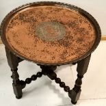 Arts & Crafts copper tray on stand by Hugh Wallace, decorated with central medallion of Lion crest