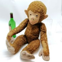 Large antique straw filled jointed monkey (Schuco?) with felt detail - 65cm high with some love worn