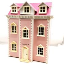 Pink painted dolls house to include a selection of assorted furniture and furnishings, 50 cm wide,