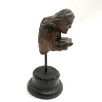 Medieval carved wooden miniature figurehead holding a book (remains of) on a metal stand - total