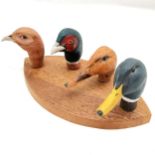 Set of 4 carved walking stick handles mounted on a board, duck, pheasant, grouse and a duck. all