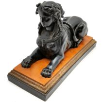 Composite Black Sphinx on marble style base 23cm long. No obvious signs of damage.