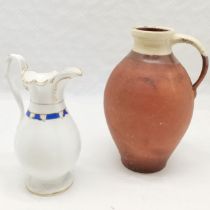 Antique terracotta dairy jug, crack to handle, 26 cm high t/w Staffordshire jug, 20 cm high.