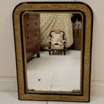 Antique gilt and ebonised framed over mantle mirror, with foxing to the mirror plate, but