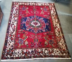 Turkish style rug with central medallion on blue/red background within cream and floral border, good