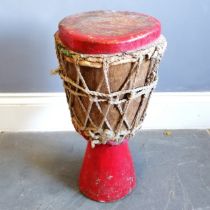 African tribal red painted wooden drum with plaited string tensioners with woven cloth detail 56cm