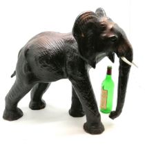 Unusual leather elephant figure - 58cm high x 62cm across ~ signs of wear and both tusks slight a/f