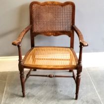 1930's oak Bergere back and seated arm chair, with carved decoration, 60 cm wide, 50 cm deep, 81
