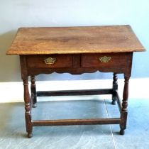 Antique oak 2 drawer side table, with brass drop handles, turned column supports, marks to the top