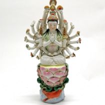 Chinese republic period porcelain figure of deity with 24 arms seated on a lily pad with carp &