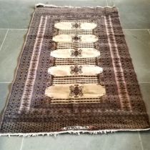 Bokhara rug, with 5 central beige medallions with geometric design within borders of similar