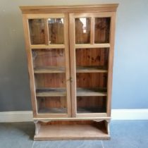 Antique stripped pine double glazed door cabinet, with open shelf to base, 105 cm wide, 31 cm