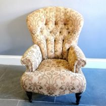 Victorian style button back armchair upholstered in a floral tapestry beige coloured material, in