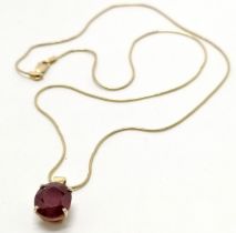 Unmarked gold (touch tests as 14ct) ruby (10.5mm x 9.5mm) pendant on a 9ct marked gold 42cm