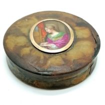 Antique ciricular box with hand painted porcelain panel depicting a female saint playing a church