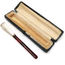 Vintage Cherry Amber and mother of pearl cigarette holder in original blue leather retail box. 11 cm