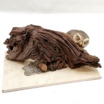 Hand made sculpture of an owl peering over a piece of driftwood at a tasty mouse on a tile base -