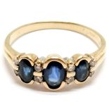 9ct marked gold sapphire (3) and diamond (8) ring in rub over mount ~ size Q & 2.3g total weight