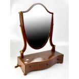 An Edwardian mahogany shield-shaped dressing table mirror with roundel inserts and three small