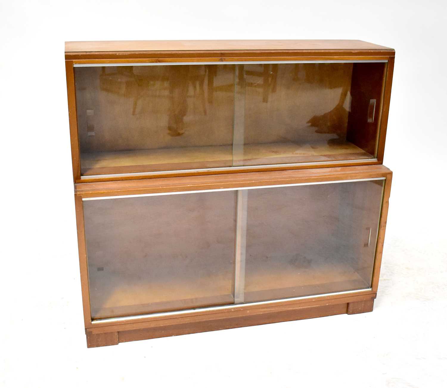 A two-section stacking bookcase with sliding glass doors, height 80cm, length 89cm, width of top