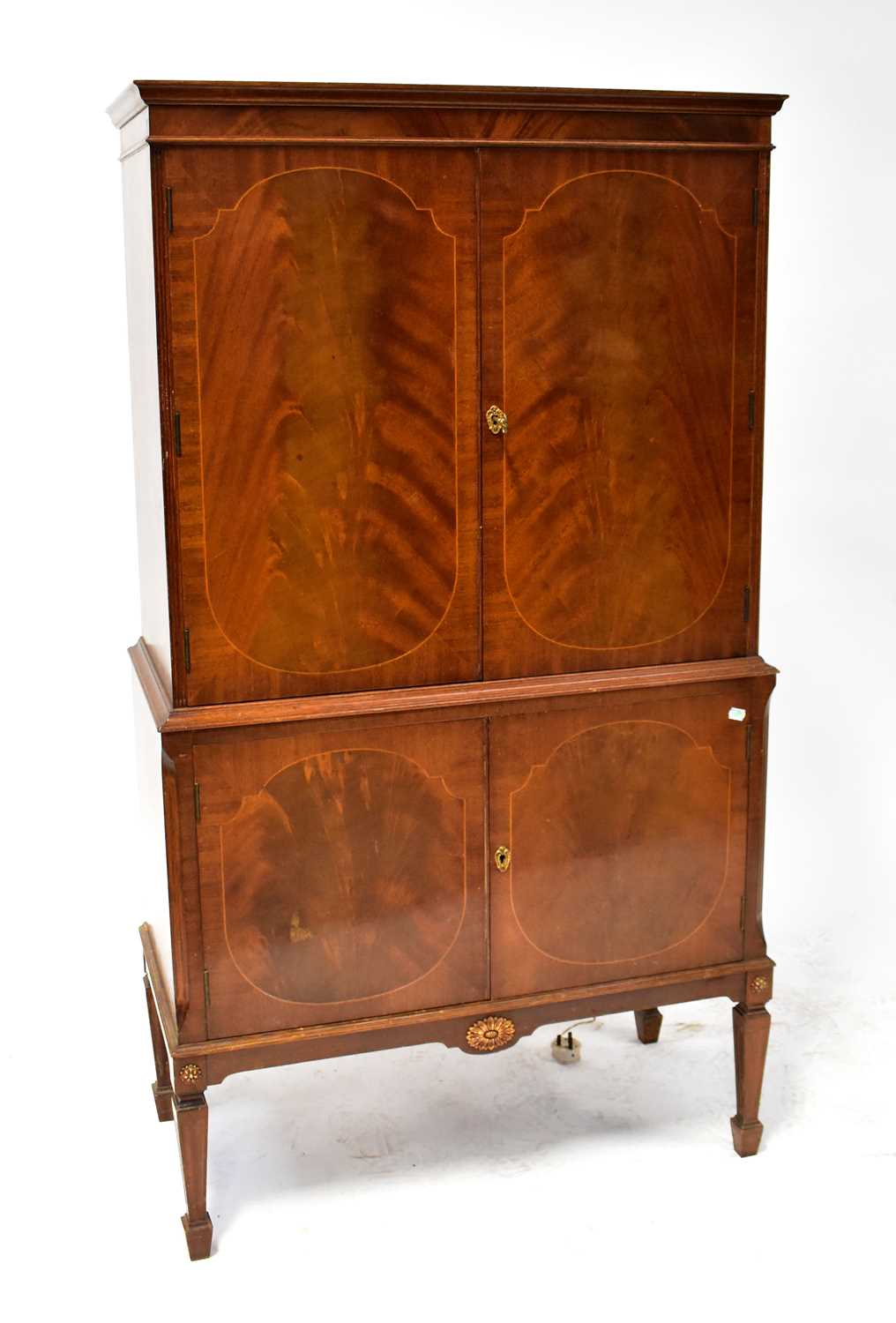 A Regency-style mahogany cabinet opening to reveal a cocktail cabinet fitted with shelves and