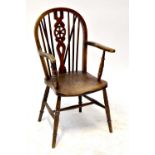 A 19th century provincial, probably elm Windsor chair with wheel back splat, united with an H-