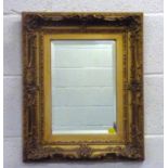 A modern rectangular bevel edge wall mirror in an ornate gilt wood picture frame, 55 x 45cm.55 x