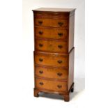 A reproduction walnut veneered small chest-on-chest, 131 x 54 x 42cm.131 x 54 x 42cm