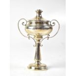 A George V hallmarked silver cup/travelling chalice with cover and scrolling handles, to stepped