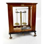 EIMER & AMEND; an oak cased set of pharmaceutical scales with applied maker's plaque, further