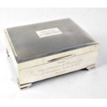 An Elizabeth II hallmarked silver engine turned cigarette box with cartouche to top inscribed '