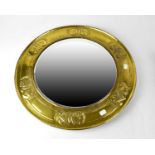 An early 20th century brass Arts & Crafts circular bevel edge wall mirror, diameter 54cm.Condition