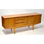 A 1960s teak sideboard with central fall front and three drawers, flanked by a pair of cupboard