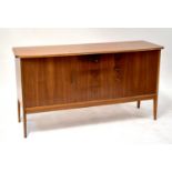 VANSON; a 1960s teak sideboard with shaped top above three short drawers, flanked by a pair of