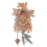 A German 20th century cuckoo clock with oak leaf, bird and chick carving.Please note that this lot