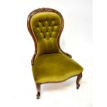 A 19th century walnut button back nursing chair raised on castors.There are some areas that show old