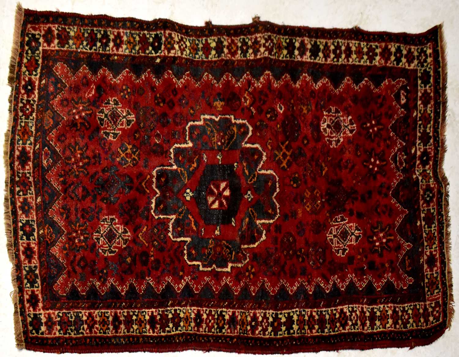 An Iranian Yolmut Kepsi navy blue and dark red ground hand knotted rug, 145 x 105cm.145 x 105cm